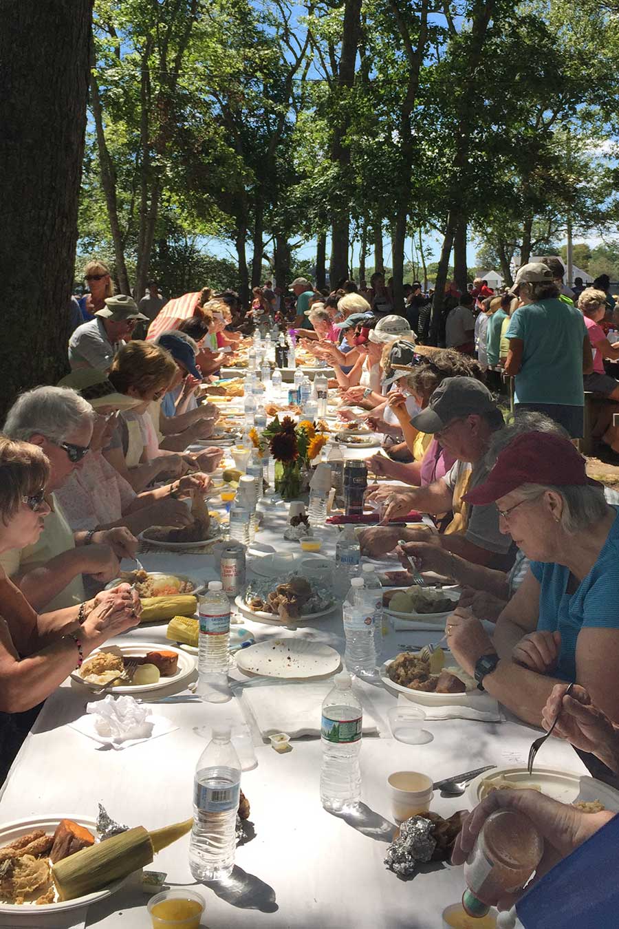 Table of Clambake participants eating