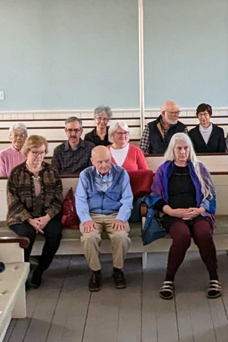People sitting in prayer at Allen's Neck Friends Meetinghouse